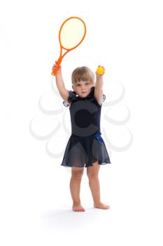 Little girl playing tennis in the studio. Isolate on white.