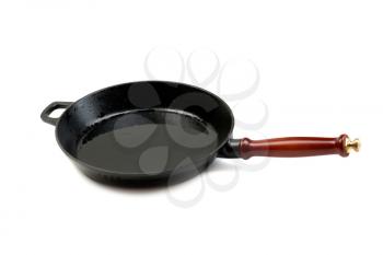 Empty pan with wooden spoon top view. Objects isolated on white background.