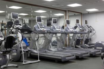 modern gym with treadmills and free weights.