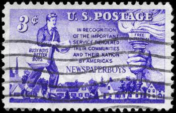 Royalty Free Photo of 1952 US Stamp Shows the Newspaper Boy, Torch and Group of Homes