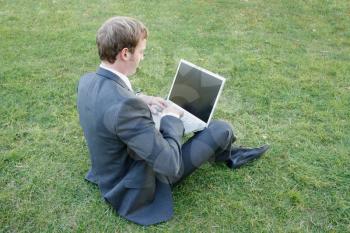Royalty Free Photo of a Businessman Working Outdoors