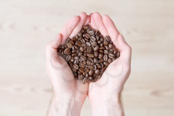 Royalty Free Photo of a Person Holding Coffee Beans