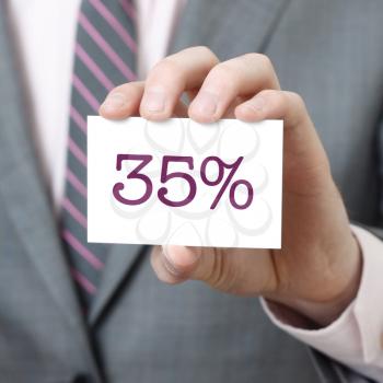 35% written on a card held by a businessman