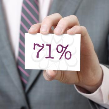 71% written on a card held by a businessman