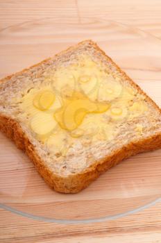 slice of whole grain bread with butter and honey
