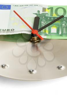 euro bill on a metal wall clock on white background