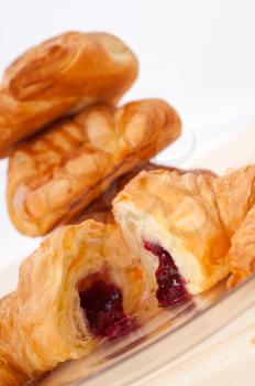 fresh baked croissant French brioche filled with berries jam