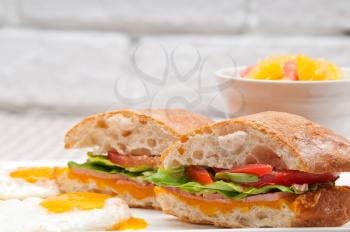 fresh ciabatta panini sandwich with eggs tomato lettuce