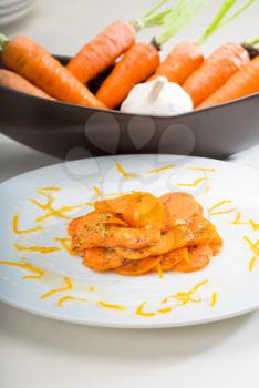 fresh  and healthy Honey glazed carrots on a plate with tyme on top