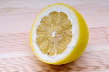 fresh ripe lemon cutted in half closedup over wood table