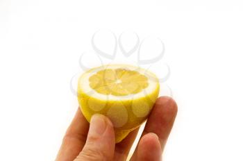 fresh ripe lemon cutted in half hold in hand closedup