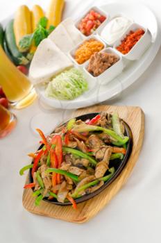 original fajita sizzling smoking hot served on iron plate and fresh vegetables on background ,MORE DELICIOUS FOOD ON PORTFOLIO