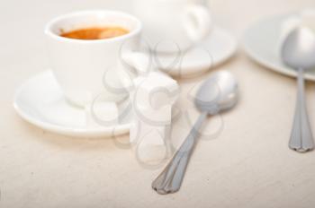 Italian espresso coffee fresh brewed macro closeup with sugar cubes