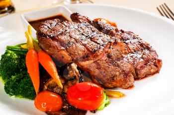 fresh grilled ribeye steak with broccoli,carrot and cherry tomatoes on side