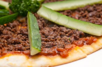 fresh baked Turkish beef pizza with cucumber on top