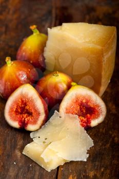 italian pecorino cheese and fresh figs macro closeup over old wood boards