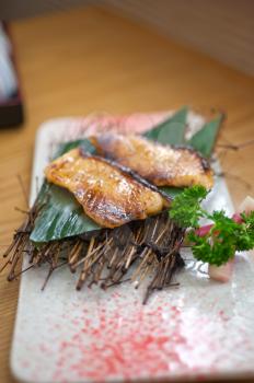 Japanese style teppanyaki roasted cod fish on palm leaf