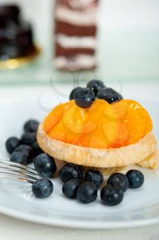 fresh blueberry and tangerine orange cream cupcake homemade closeup macro