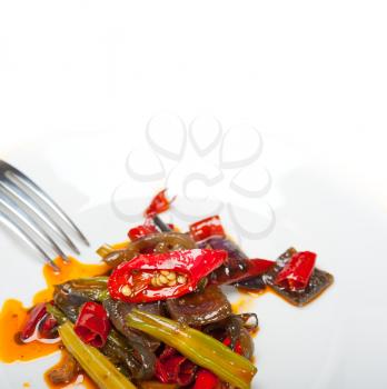 fried chili pepper and vegetable on a iron wok pan