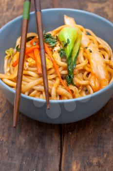 hand pulled stretched Chinese ramen noodles on a bowl with chopstick