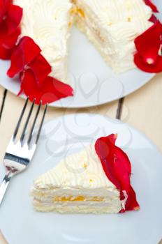 whipped cream mango cake with red rose petals 