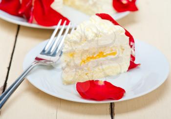 whipped cream mango cake with red rose petals 