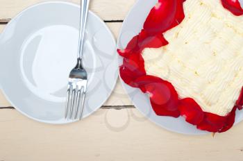 whipped cream mango cake with red rose petals 