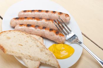 traditional fresh German wurstel sausages grilled with yellow mustard 