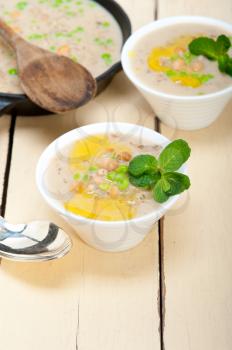 Hearty Middle Eastern Chickpea and Barley Soup with mint leaves on top