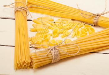 bunch of Italian pasta type on a white rustic table 