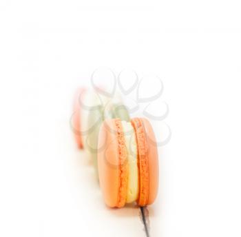 colorful french macaroons over a white rustic wood table 