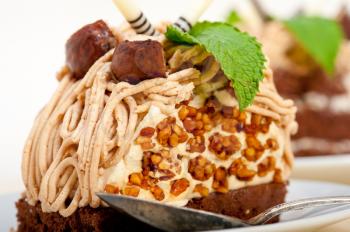 fresh baked chestnut cream cake dessert over rustic white wood table 