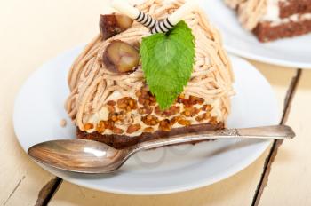 fresh baked chestnut cream cake dessert over rustic white wood table 