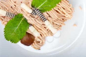 fresh baked chestnut cream cake dessert over rustic white wood table 