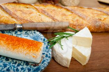 French cheese and fresh  baguette on a wood cutter