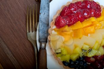 fresh homemade fruits cake pie over wood cutting board