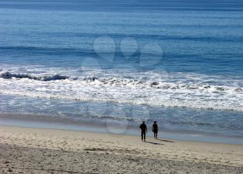 Royalty Free Photo of Two People Walking on the Beach