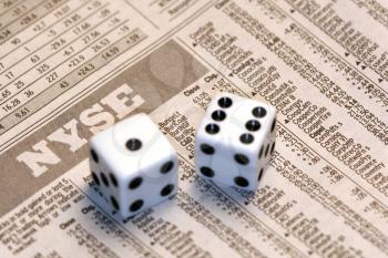 Royalty Free Photo of Dice on a Newspaper