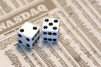 Royalty Free Photo of Dice on a Newspaper