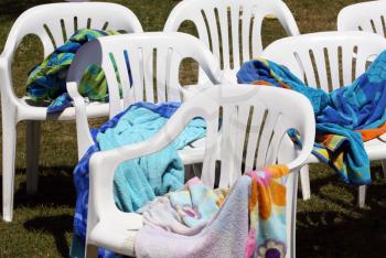 Royalty Free Photo of Plastic Chairs and Towels