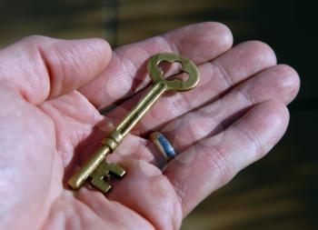 Royalty Free Photo of a Person Holding a Skeleton Key