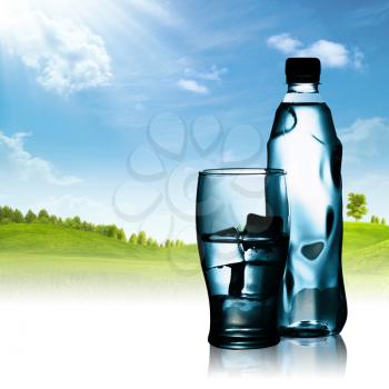 Royalty Free Photo of Bottled Water and a Landscape