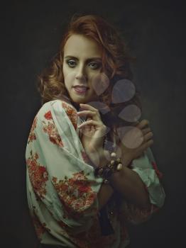 Hippie posing. Retro styled female portrait with red head woman