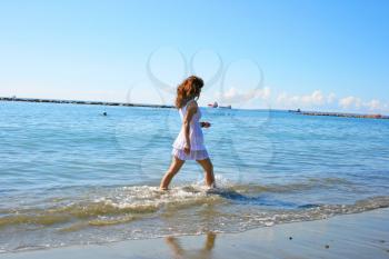 Royalty Free Photo of a Woman Walking on the Beach