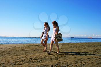 Royalty Free Photo of Two Women Walking on the Beach