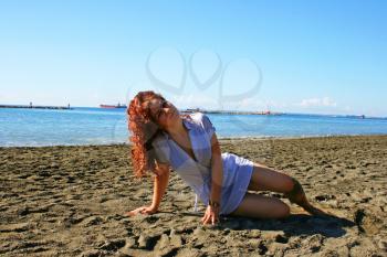 Royalty Free Photo of a Woman Sitting on the Beach