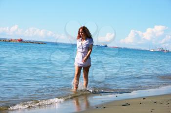 Royalty Free Photo of a Woman Walking on the Beach