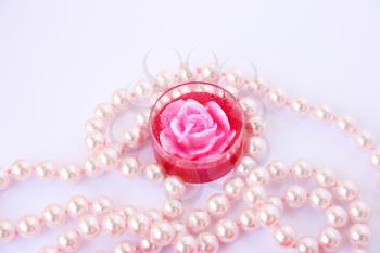 Royalty Free Photo of a Candle and Pearls