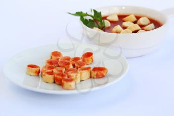 Croutons and sauce on gray background.