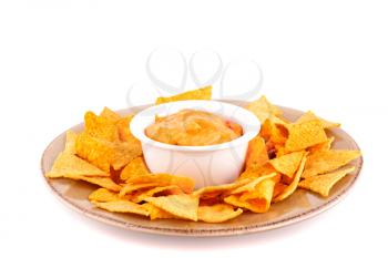 Nachos and cheese sauce isolated on white background.
